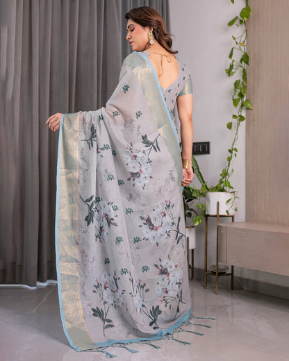 Elegant Ice Grey Handloom Linen Saree with Floral Print, Gold Zari Border & Tassel Detailing | Attached Blouse Piece | 5.5m Saree + 0.8m Blouse